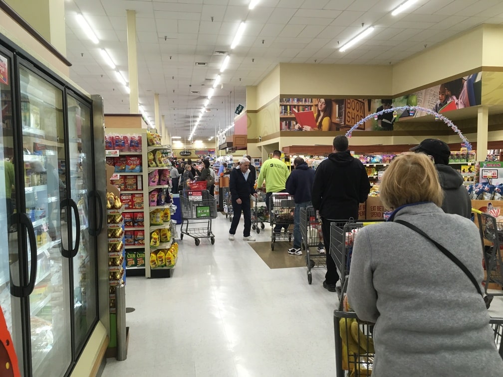 Crowd of people queuing at supermarket