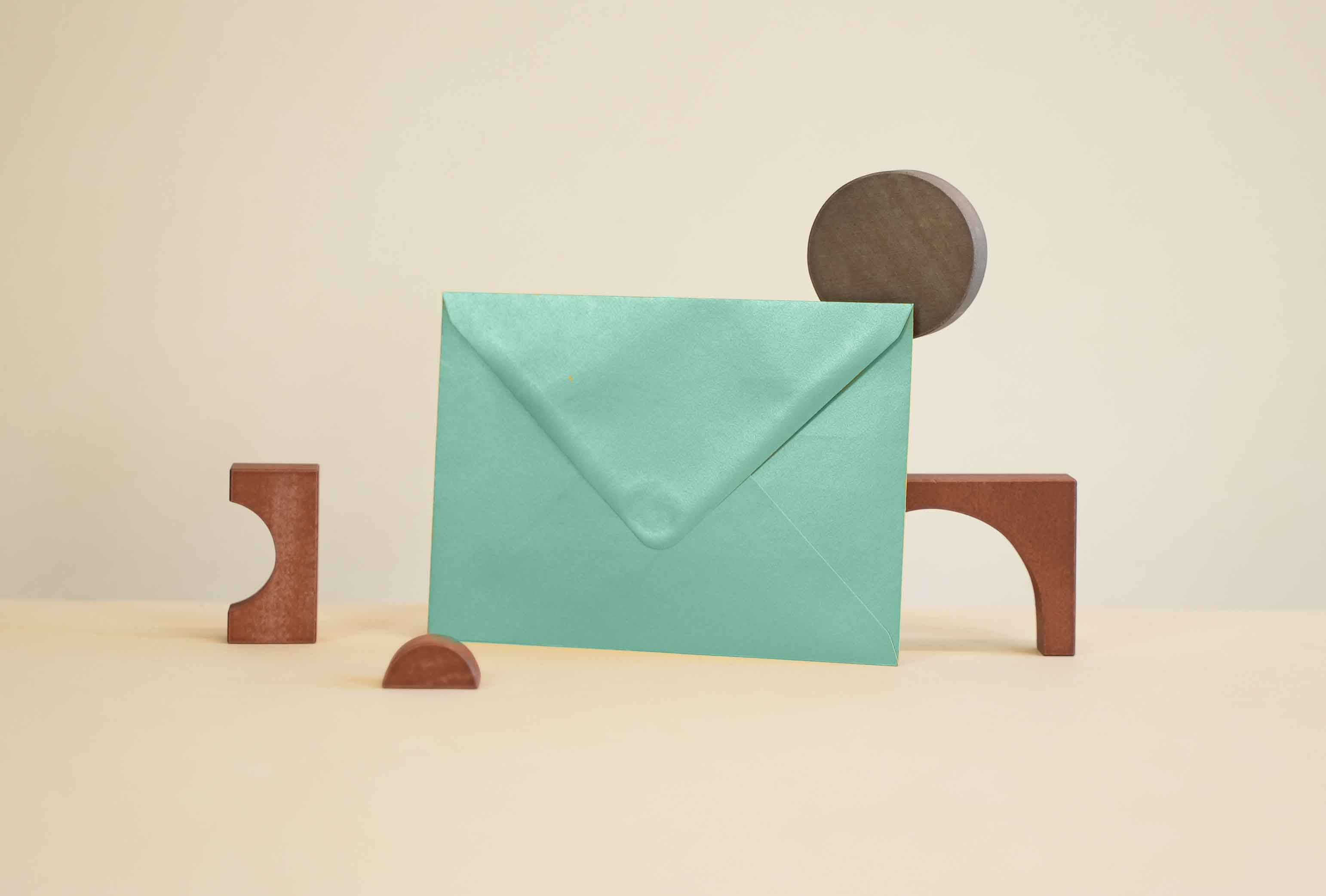 Green envelope on beige background