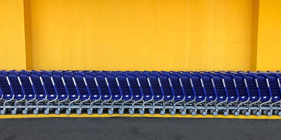 Blue shopping carts against yellow background