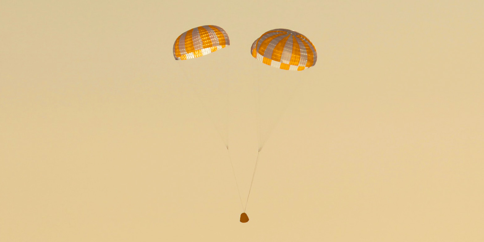 Small object dropping held up by parachutes
