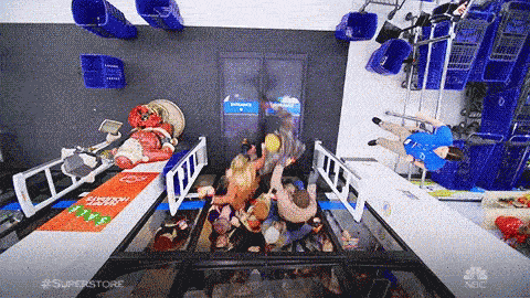 GIF of people barging through store doors and pushing each other out of way