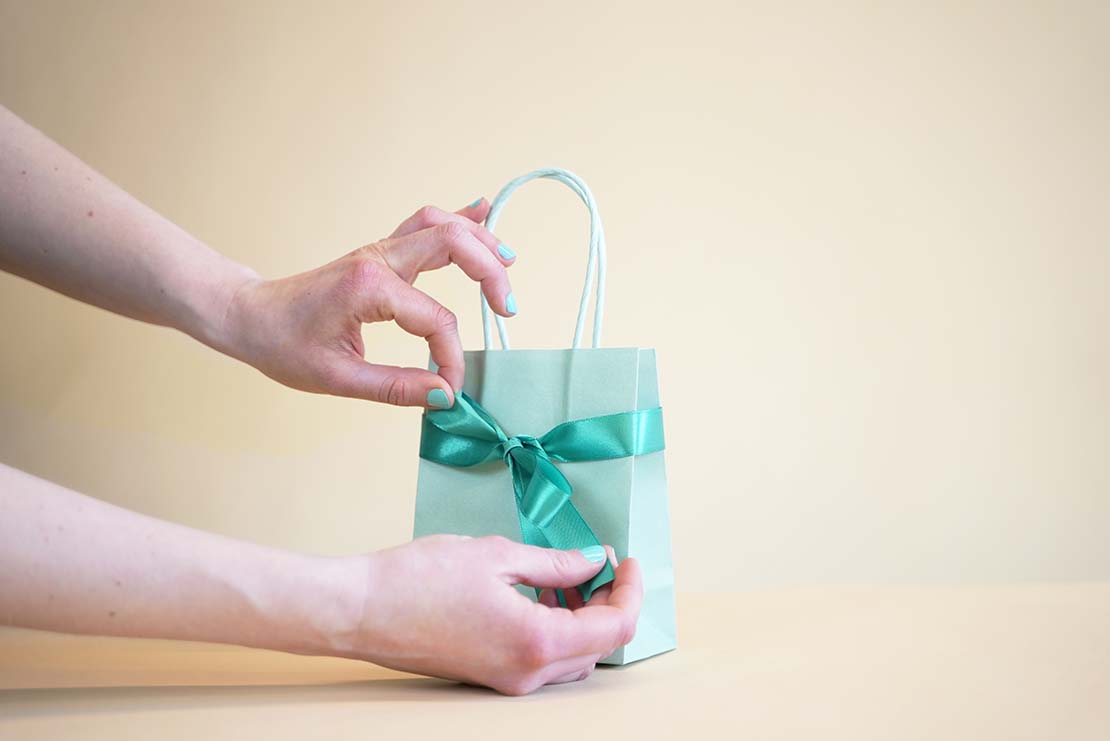 blue gift bag with hands