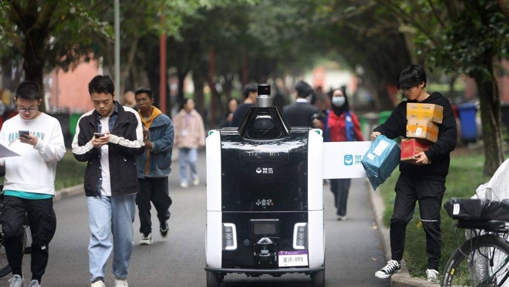 Singles' Day delivery robots driving through crowd of students