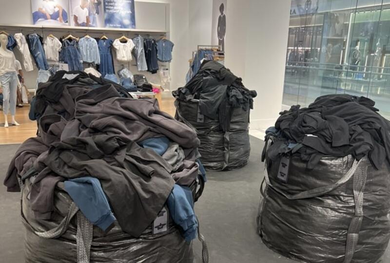 Gap store with large black garbage bags full of clothing