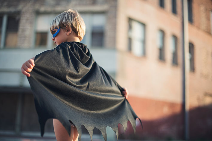 Child with gray Batman superhero cape